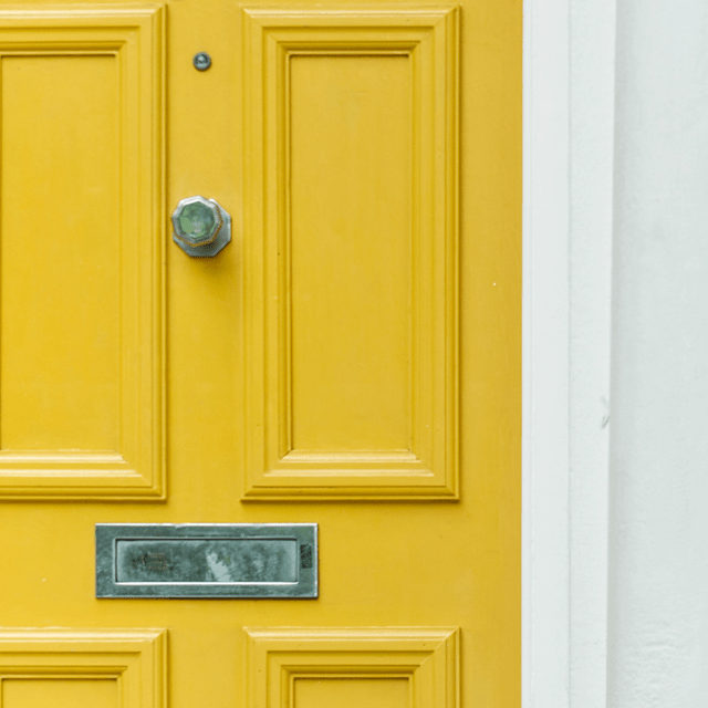 Close-up of a yellow front door.